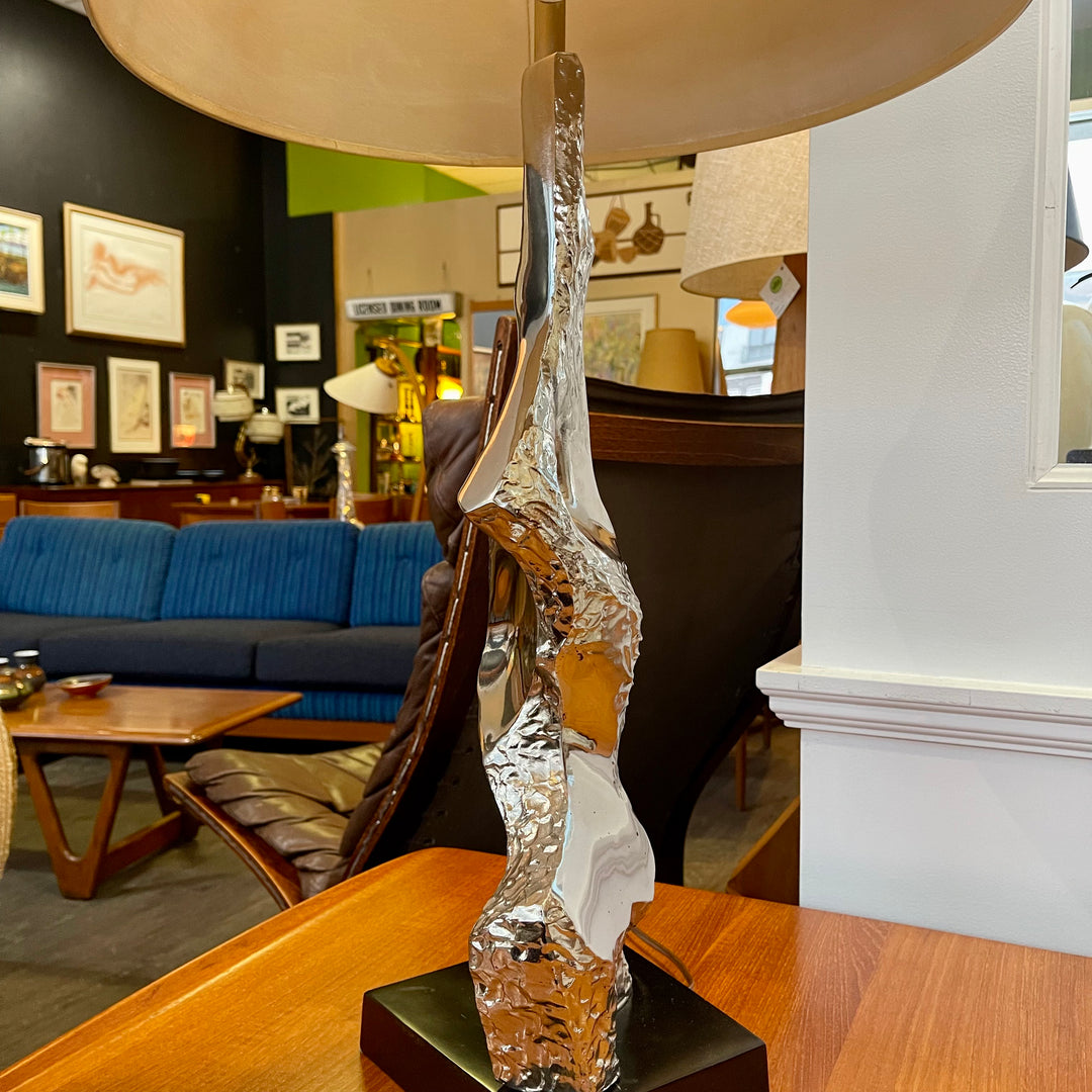 Richard Barr Brutalist Chrome Lamp for Laurel Lamp CoStanding as a testament to the Brutalist movement's influence on mid-century design, the lamp features a robust chrome base that exudes an air of strength and solidity. 