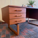 Constructed from rich and durable teak wood, this DYRLUND desk features a design that encapsulates the essence of Mid-Century Modern aesthetics. To the right, a spacious drawer provides practical storage for documents, ensuring a clutter-free workspace. On the left, three drawers offer additional organizational space, perfect for keeping essentials close at hand.