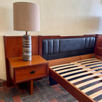 Built-in teak nightstand on R.S. Associates bed with black vinyl-lined drawer 