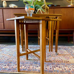 Load image into Gallery viewer, Mid Century Poul Hundevad Nesting Tables, a timeless and versatile addition to your living space. This exquisite set consists of five tables, with four of them ingeniously designed as drop-leaf tables that effortlessly slide beneath the main table, offering both functionality and aesthetic appeal.