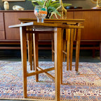 Mid Century Poul Hundevad Nesting Tables, a timeless and versatile addition to your living space. This exquisite set consists of five tables, with four of them ingeniously designed as drop-leaf tables that effortlessly slide beneath the main table, offering both functionality and aesthetic appeal.