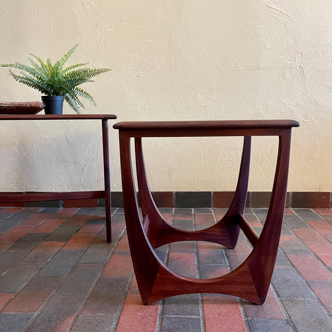 Teak G Plan nesting tables. Chrome Lamp with black shade, fern plant and an ashtray sits on top.There are 2 tables that pull out from under the main tablw. 