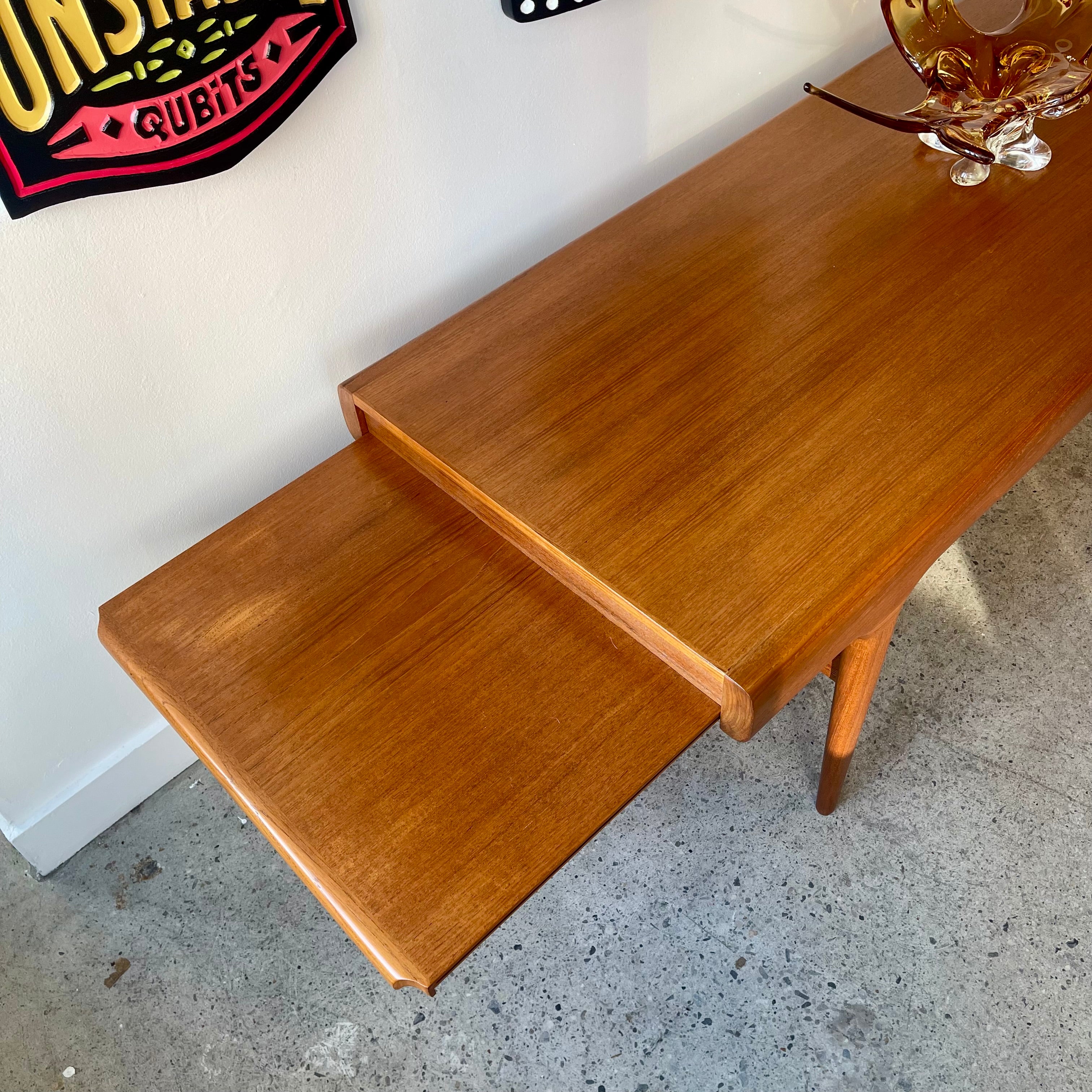 Side view of right extension on Johannes Andersen Danish modern teak table