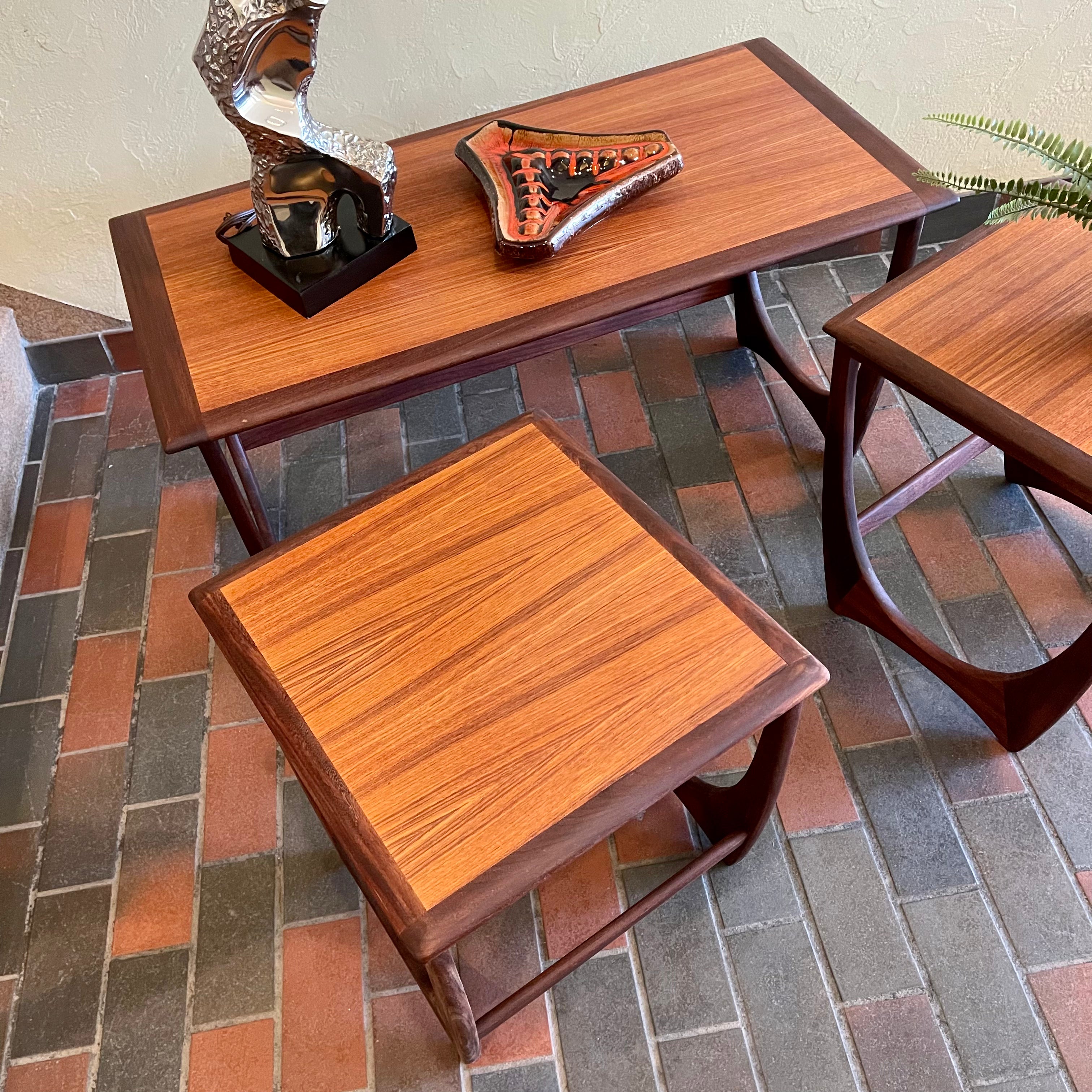 Teak G Plan nesting tables. Chrome Lamp with black shade, fern plant and an ashtray sits on top.There are 2 tables that pull out from under the main tablw. 