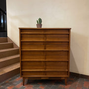 Crafted from rich walnut wood, this GIBBARD dresser boasts a warm, inviting tone that adds a touch of sophistication to any space.