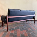 Back view of RS Associates teak black sofa