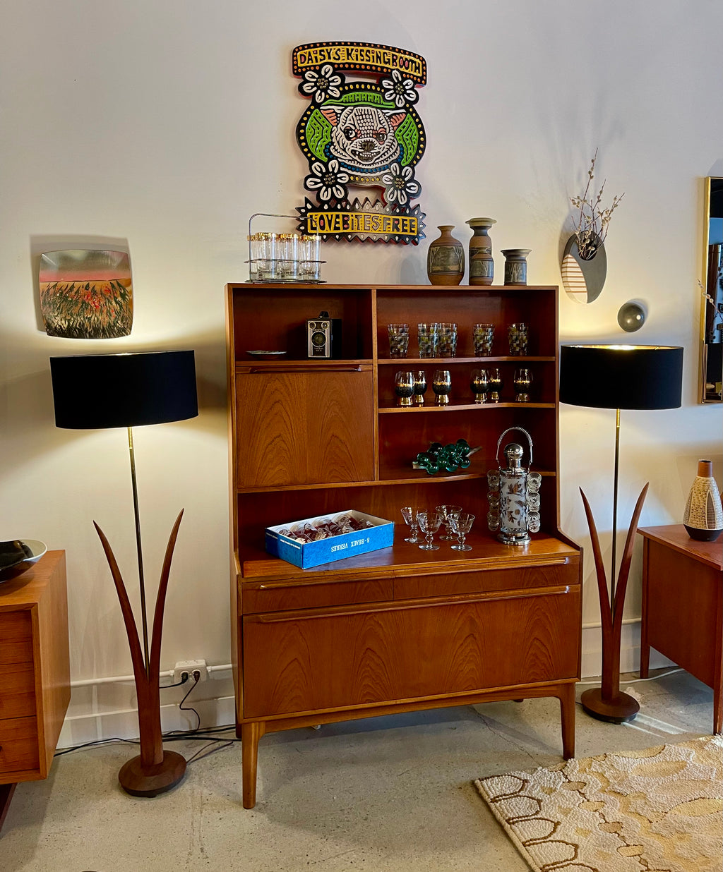 Pair of vintage mid-century walnut floor lamps with sculptural reed-inspired bases and black drum shades with gold interiors.