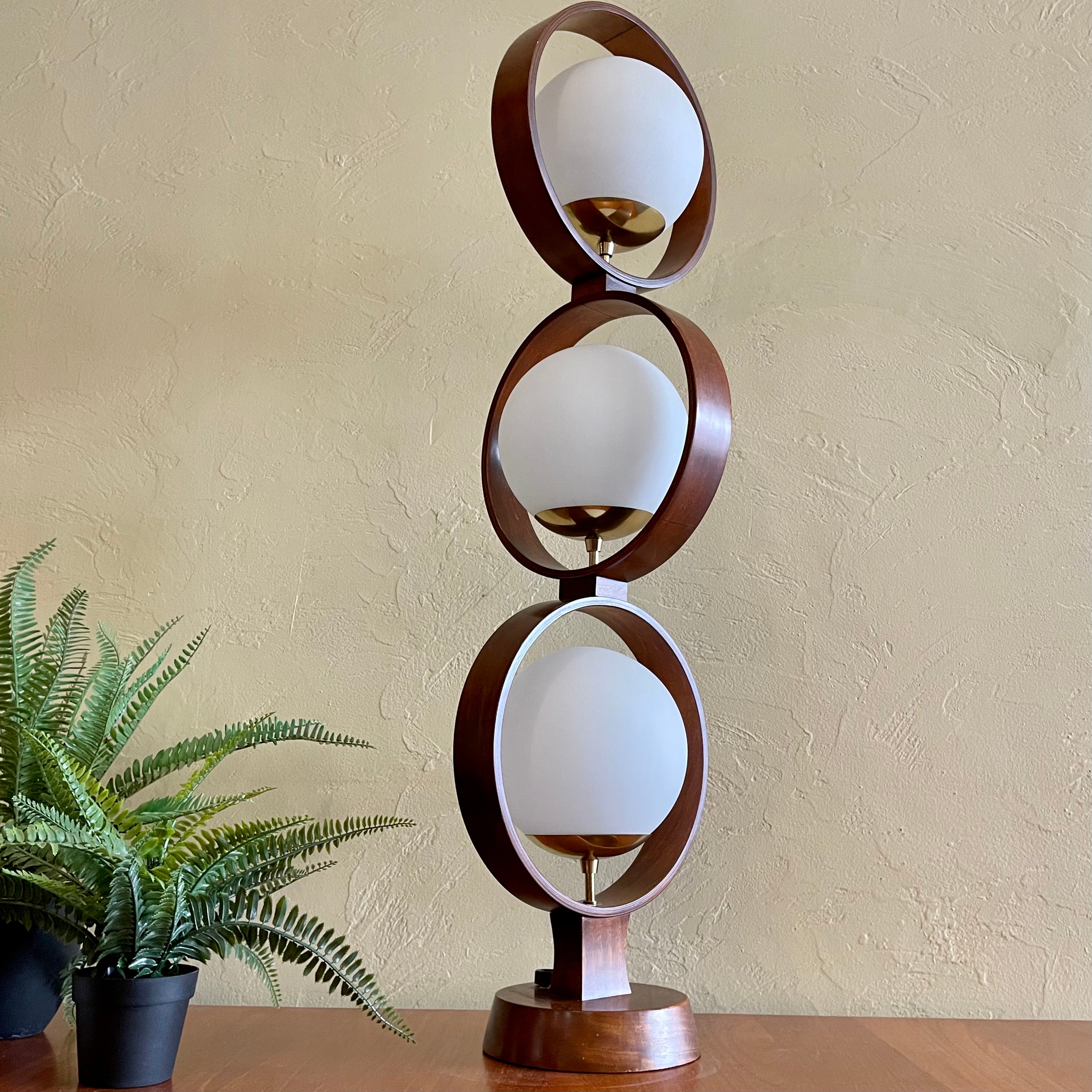 MODELINE Mid-Century Modern Globe Ring Lamp is a stunning three-tiered lighting fixture exuding a timeless Mid-Century Modern aesthetic. 