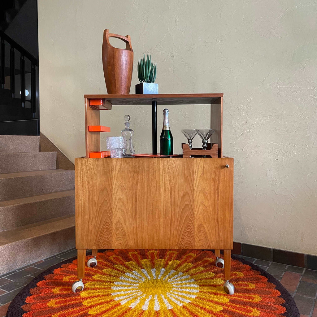 front view of Kai Kristiansen teak drinks cabinet with hydraulic pop-up bar storage open