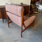 Back view of mid-century Danish teak lounge chair with striped upholstery