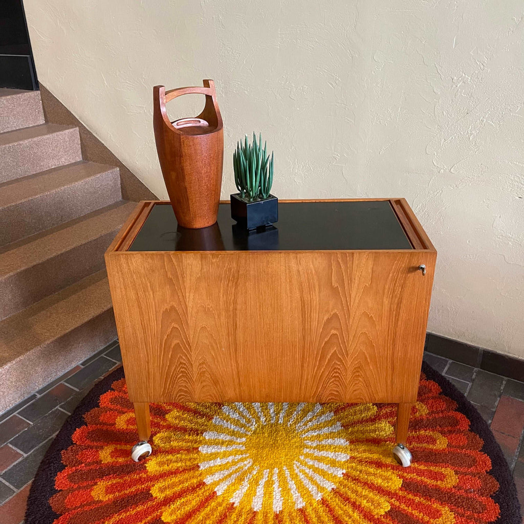 Black laminate top on Kai Kristiansen Danish teak hydraulic drinks cabinet