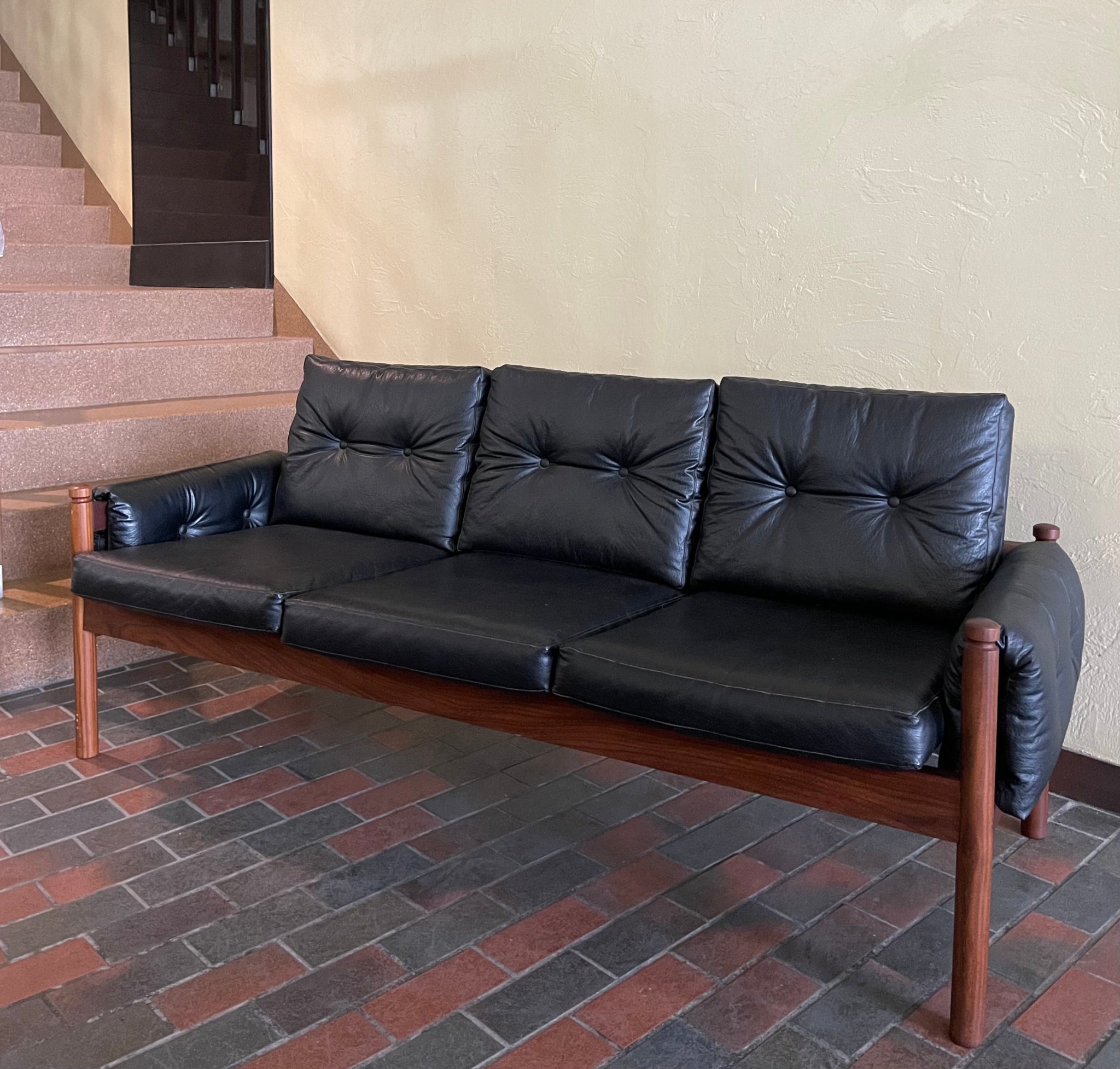 RS Associates teak black sofa with mid-century modern frame