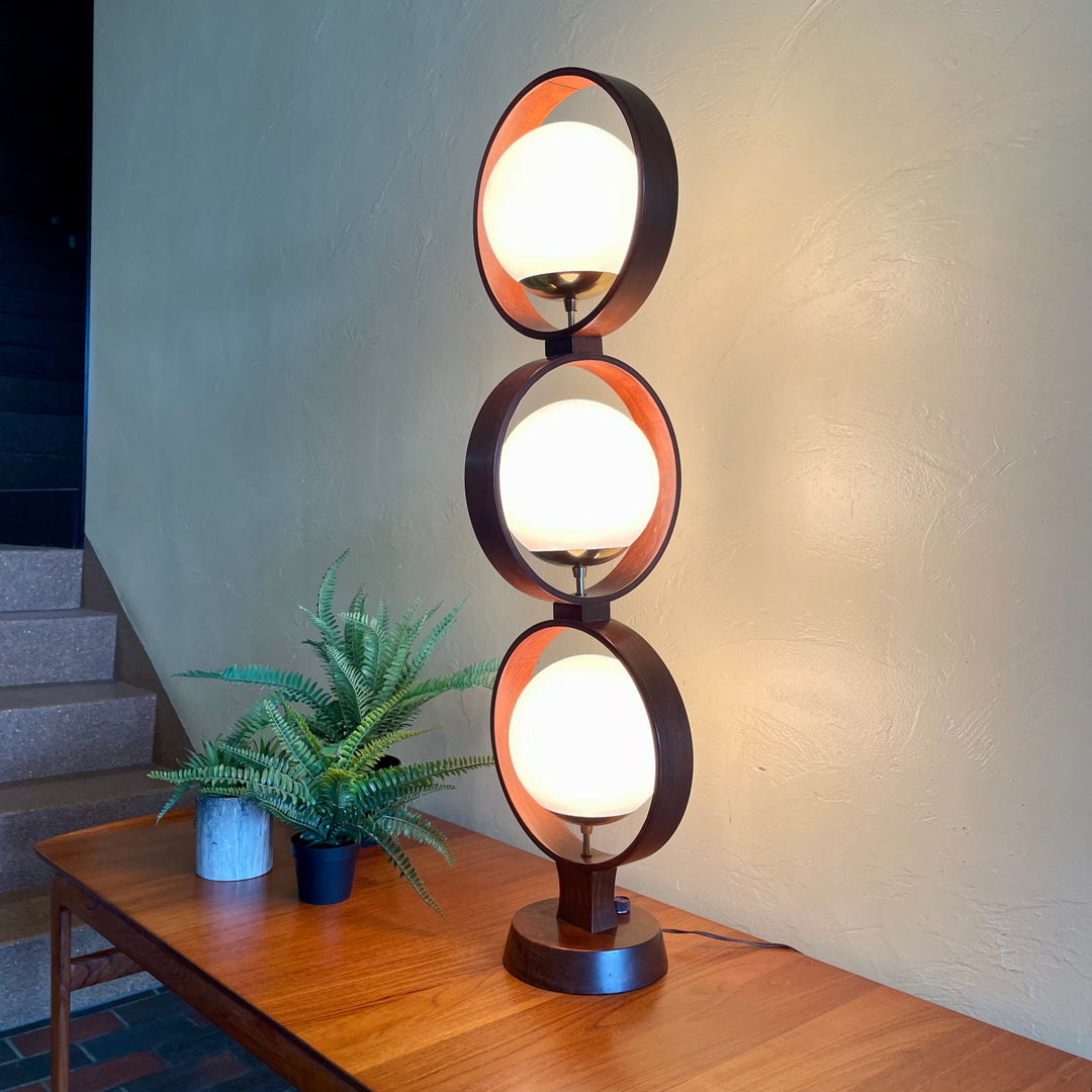 MODELINE Mid-Century Modern Globe Ring Lamp is a stunning three-tiered lighting fixture exuding a timeless Mid-Century Modern aesthetic. 