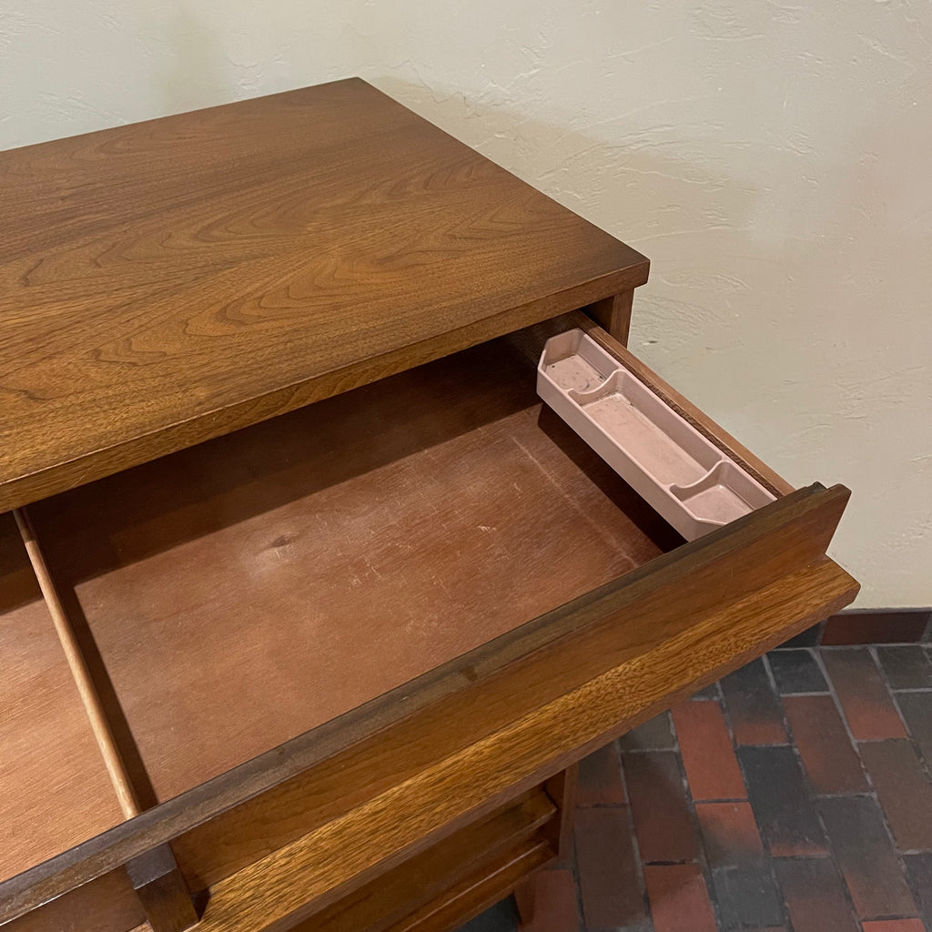 Crafted from rich walnut wood, this GIBBARD dresser boasts a warm, inviting tone that adds a touch of sophistication to any space.
