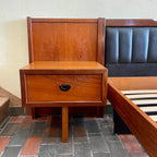 Teak nightstand detail on R.S. Associates bed with black vinyl-lined drawer