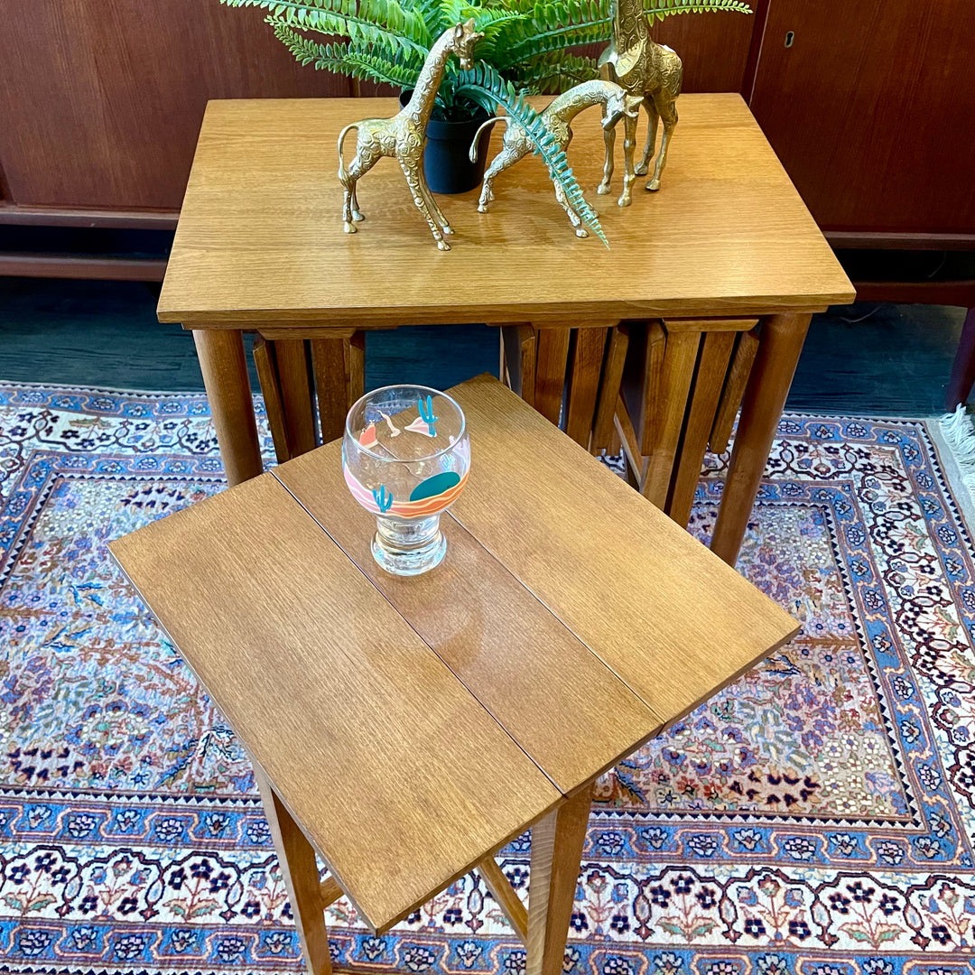 Mid Century Poul Hundevad Nesting Tables, a timeless and versatile addition to your living space. This exquisite set consists of five tables, with four of them ingeniously designed as drop-leaf tables that effortlessly slide beneath the main table, offering both functionality and aesthetic appeal.