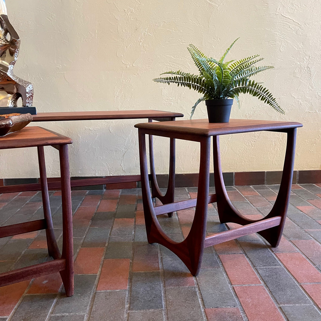 Teak G Plan nesting tables. Chrome Lamp with black shade, fern plant and an ashtray sits on top.There are 2 tables that pull out from under the main tablw. 