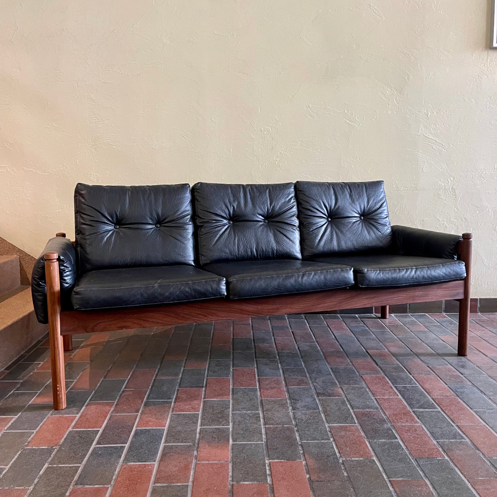 Vintage RS Associates sofa with black upholstery and teak frame