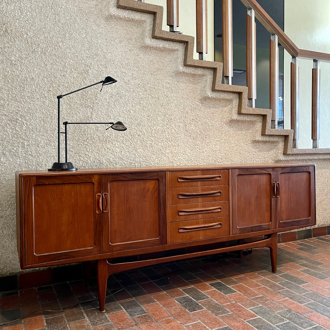 Crafted with attention to detail, this Mid Century Modern "Fresco" Teak Credenza by G Plan features four dovetail drawers for convenient storage, seamlessly integrated with additional storage on either side, offering even more organizational space.