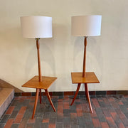  Mid Century Teak Tri-pod Side Table Lamps,are crafted with the sophistication of mid-century design, these lamps boast a rich teak finish that exudes warmth and refinement. The slender tripod base gracefully elevates the table and the lamps, creating a harmonious balance between simplicity and style.