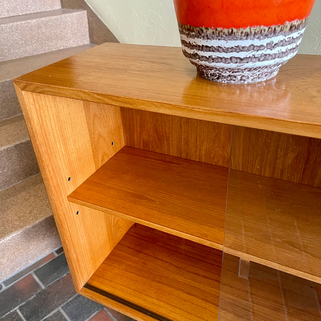  Mid-century Teak Credenza | Hutch with Adjustable Shelving. This mid-century teak credenza | hutch is perfect for storing and displaying your items. Featuring two adjustable shelves, you can customize the configuration to suit your unique home. The timeless design is ideal for both office and home environments.