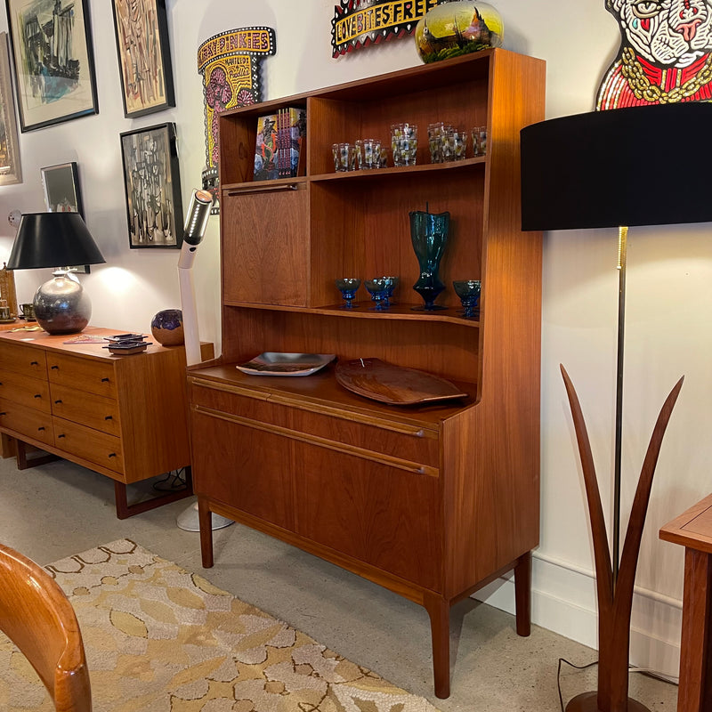 Mid-century teak display cabinet with open shelves, lower cabinet storage and warm wood grain