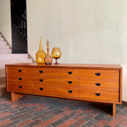 Mid-century R.S. Associates teak dresser with nine drawers and black metal pulls