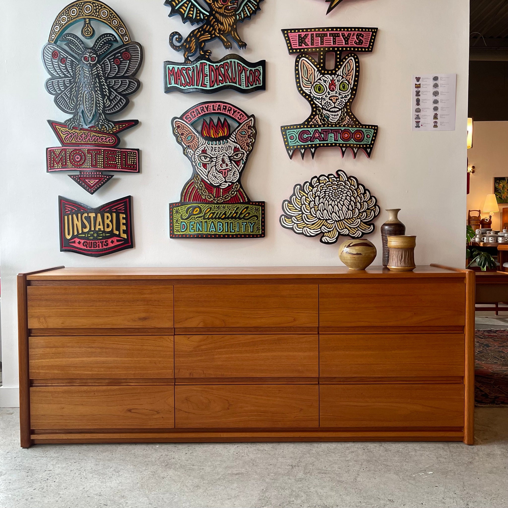 Front view of teak nine drawer dresser with integrated pulls