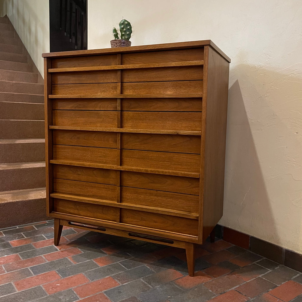 Crafted from rich walnut wood, this GIBBARD dresser boasts a warm, inviting tone that adds a touch of sophistication to any space.