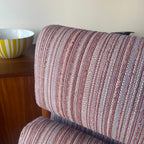 Close-up of blush pink and cream striped upholstery on Danish lounge chair