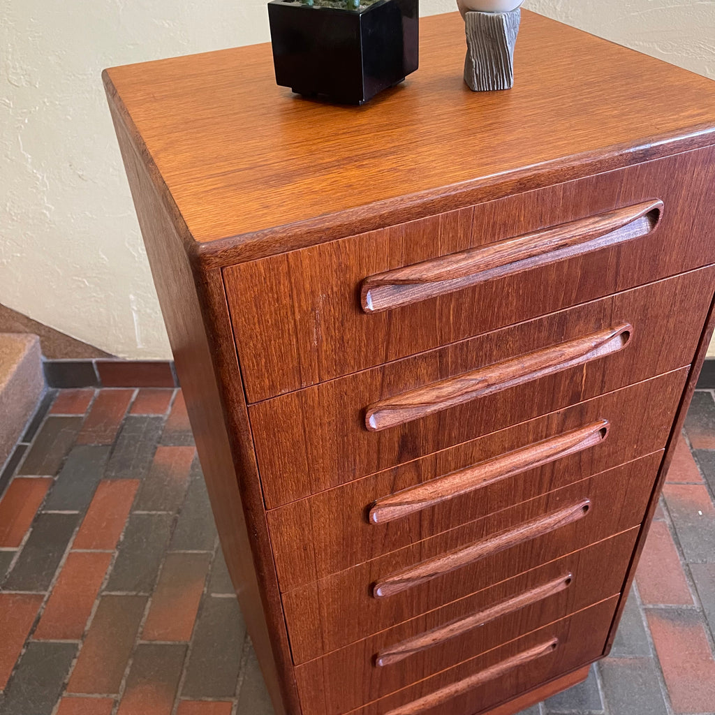 Close-up of G Plan teak chest of drawers showing recessed wooden drawer pulls and warm wood grain