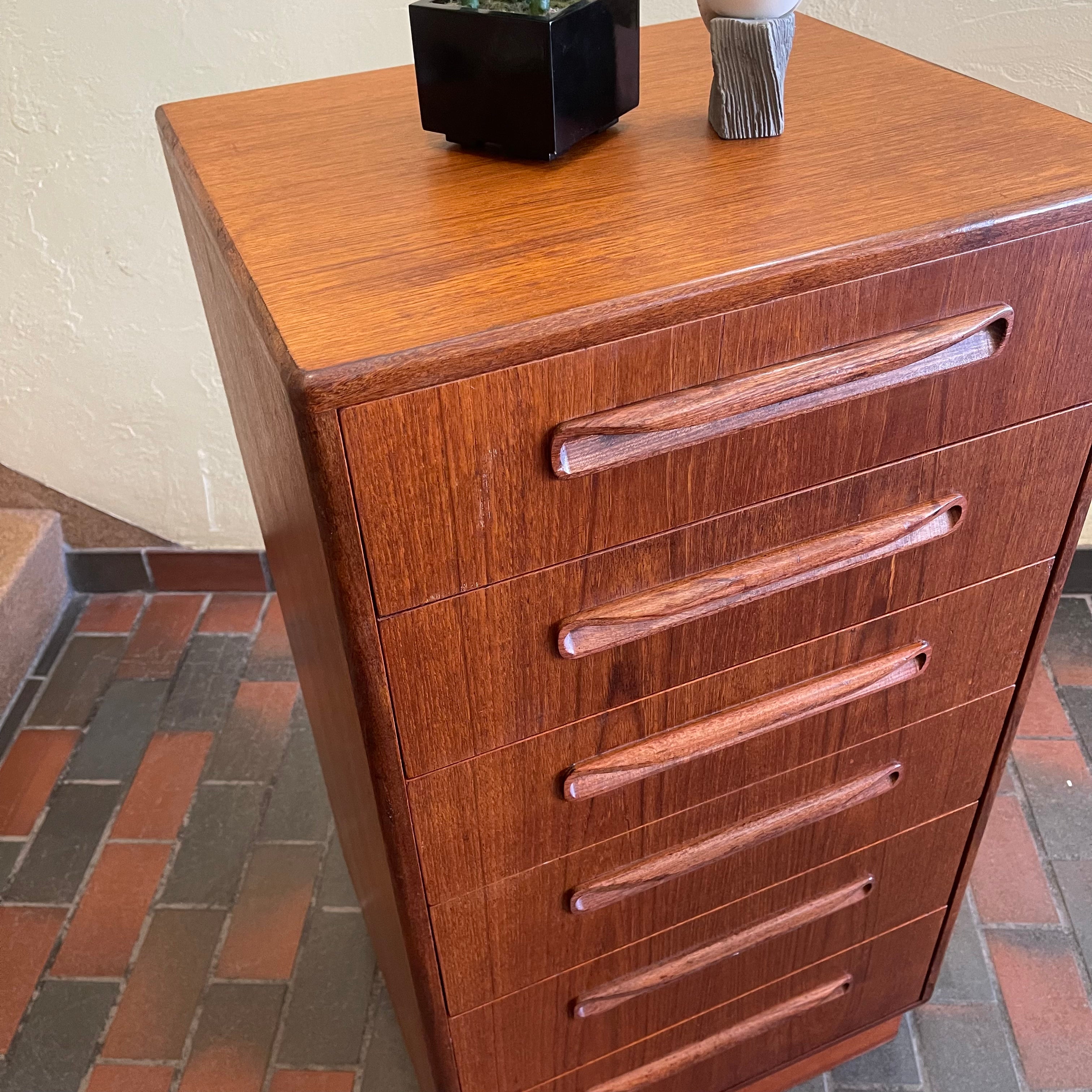 Close-up of G Plan teak chest of drawers showing recessed wooden drawer pulls and warm wood grain