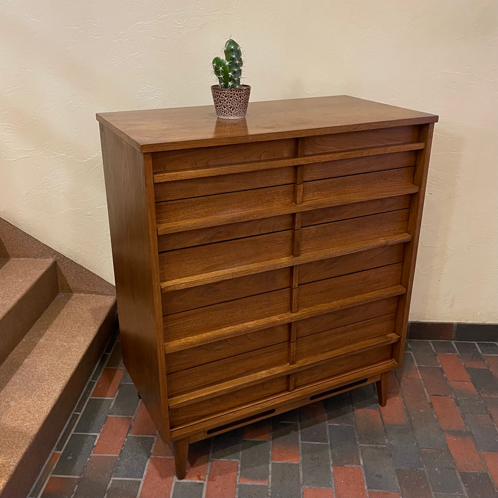 Crafted from rich walnut wood, this GIBBARD dresser boasts a warm, inviting tone that adds a touch of sophistication to any space.
