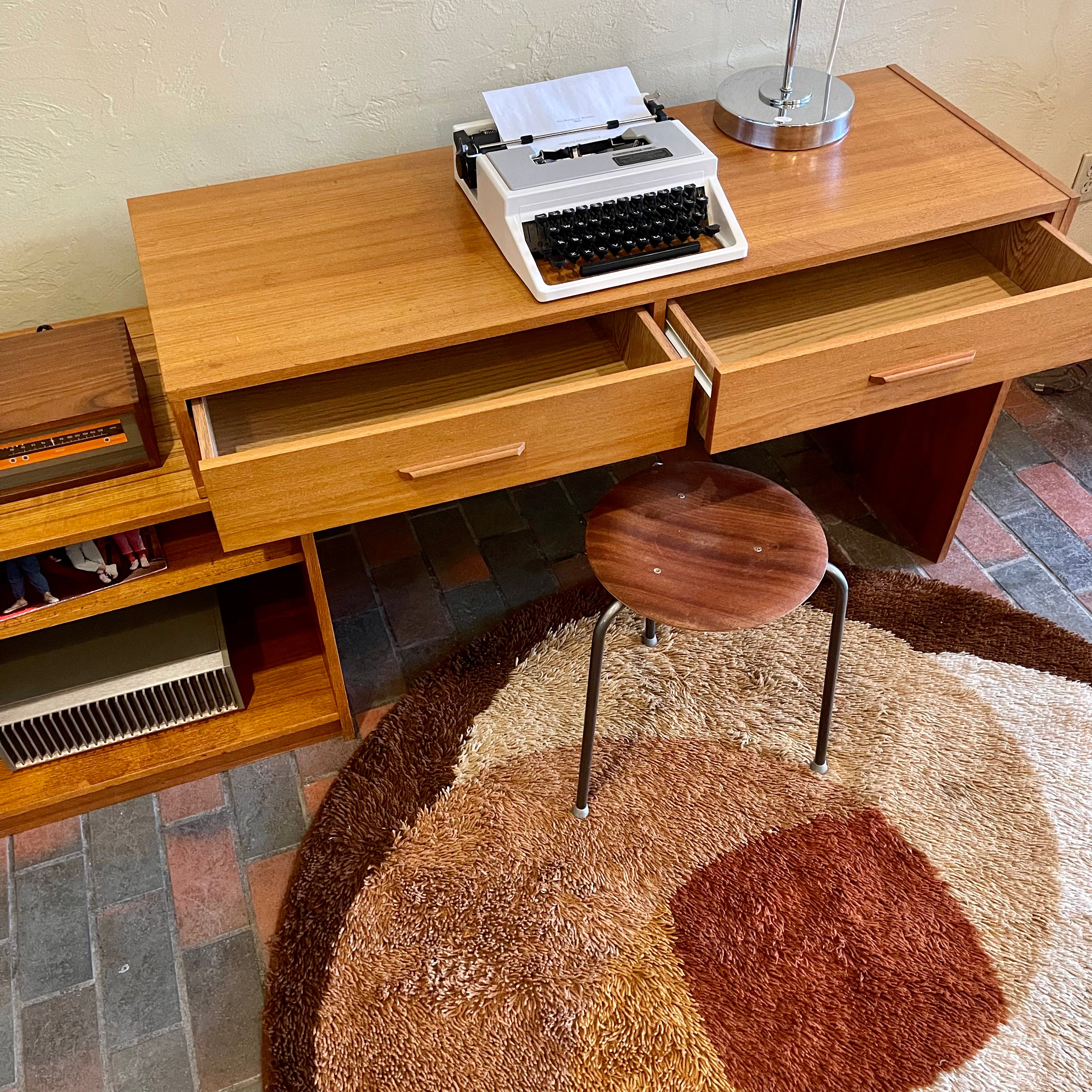 This versatile Adjustable Teak Entertainment Unit is an ideal fit for condo living. With ample storage including two drawers, it accommodates record collections and houses a stereo system