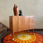 Side view of Kai Kristiansen teak bar cabinet with compact mid-century profile