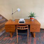 Load image into Gallery viewer, Constructed from rich and durable teak wood, this DYRLUND desk features a design that encapsulates the essence of Mid-Century Modern aesthetics. To the right, a spacious drawer provides practical storage for documents, ensuring a clutter-free workspace. On the left, three drawers offer additional organizational space, perfect for keeping essentials close at hand.
