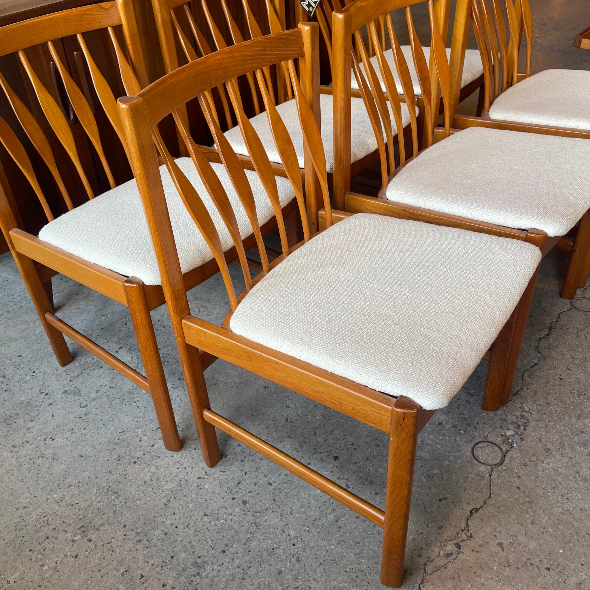 Neutral fabric upholstery detail on vintage teak dining chair
