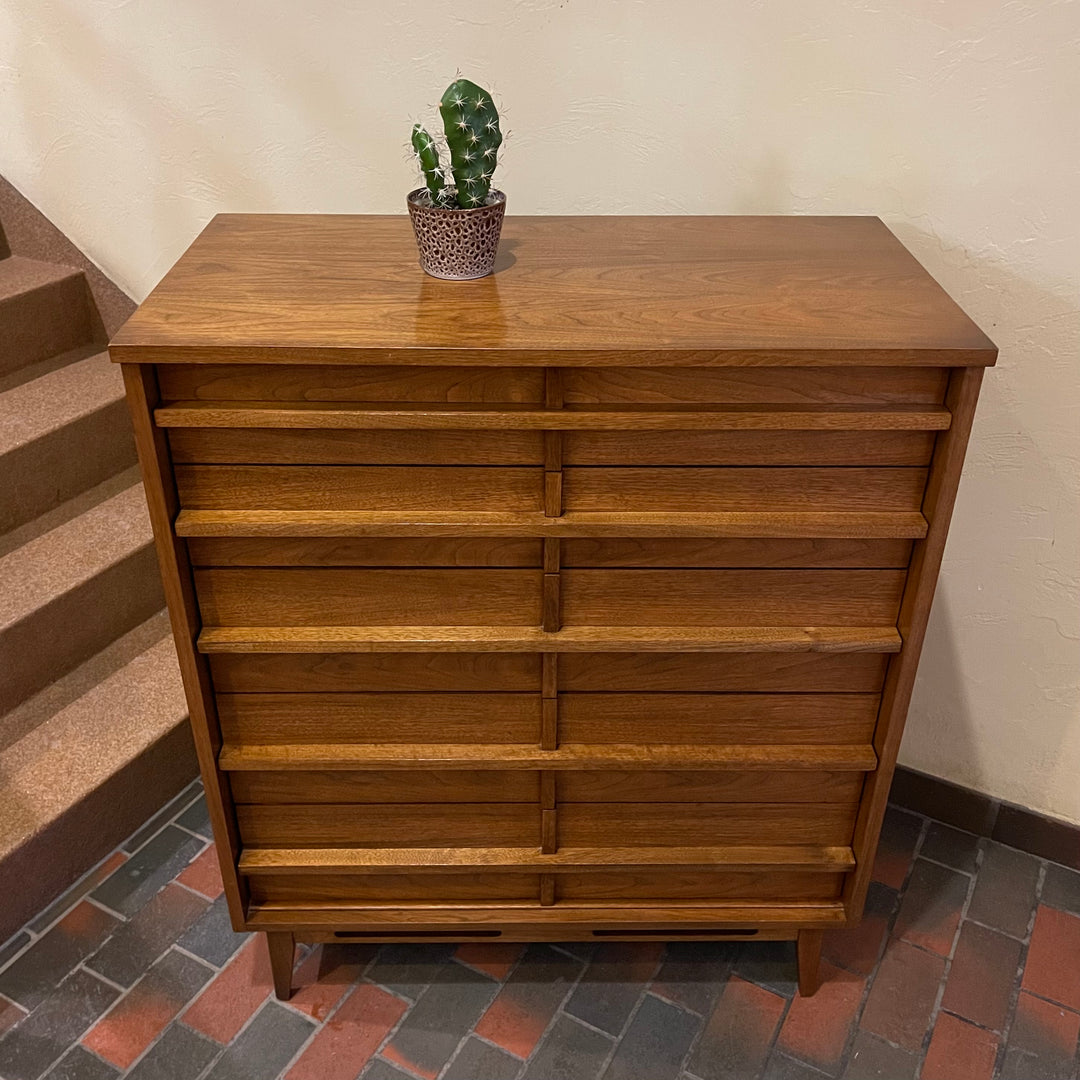 Crafted from rich walnut wood, this GIBBARD dresser boasts a warm, inviting tone that adds a touch of sophistication to any space.
