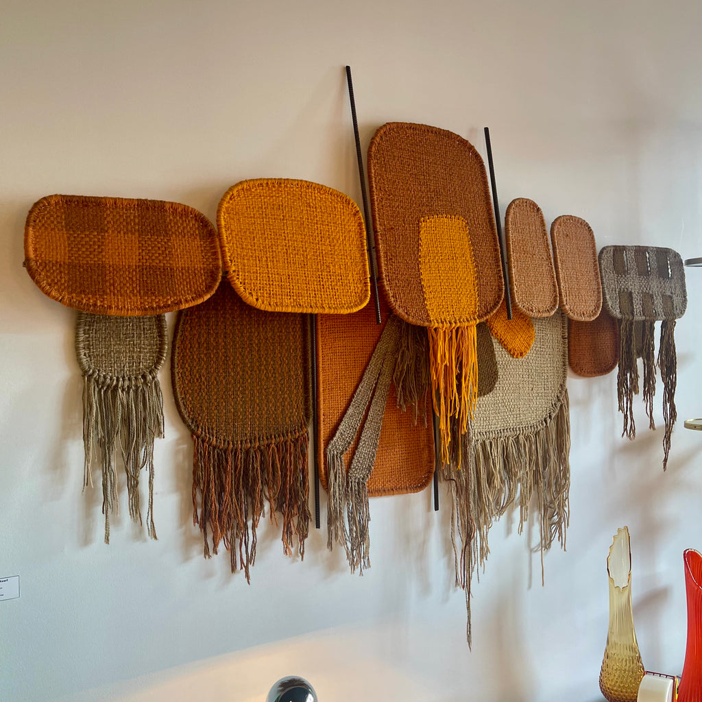 Side view of Derek Graham Whyte textile wall sculpture mounted on vertical rods
