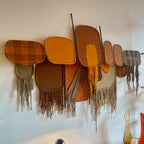 Side view of Derek Graham Whyte textile wall sculpture mounted on vertical rods