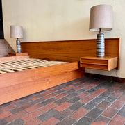 The centerpiece of any bedroom, this platform bed features a clean, minimalist design with a low-profile frame that offers a sense of spaciousness. The headboard, showcasing the natural beauty of teak, adds a touch of organic allure to the overall aesthetic. Its seamless integration with the floating nightstands on both sides creates a cohesive and balanced look.