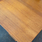 Constructed from rich and durable teak wood, this DYRLUND desk features a design that encapsulates the essence of Mid-Century Modern aesthetics. To the right, a spacious drawer provides practical storage for documents, ensuring a clutter-free workspace. On the left, three drawers offer additional organizational space, perfect for keeping essentials close at hand.