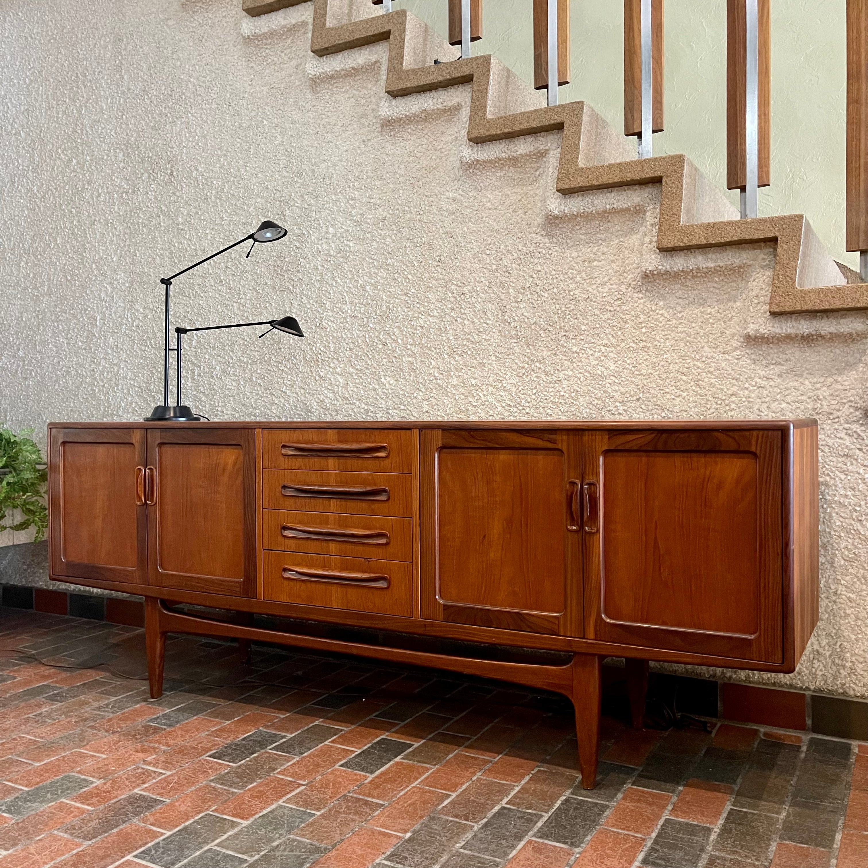 Crafted with attention to detail, this Mid Century Modern "Fresco" Teak Credenza by G Plan features four dovetail drawers for convenient storage, seamlessly integrated with additional storage on either side, offering even more organizational space.