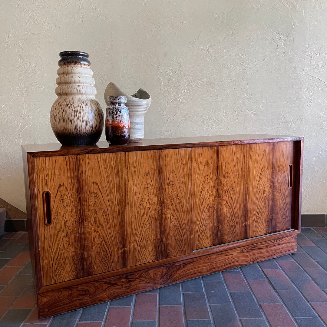 This Poul Hundevad Rosewood Credenza is crafted from rosewood, its compact size makes it perfect for apartments or smaller rooms.