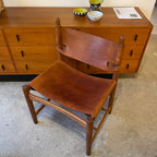 Top view of Borge Mogensen Spanish chair with leather seat and solid wood frame in vintage furniture showroom