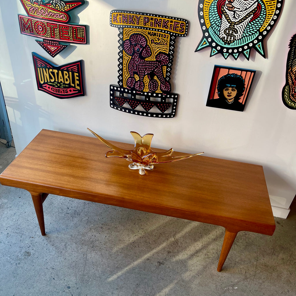 Right side view of Johannes Andersen Danish modern teak coffee table with sculpted teak frame