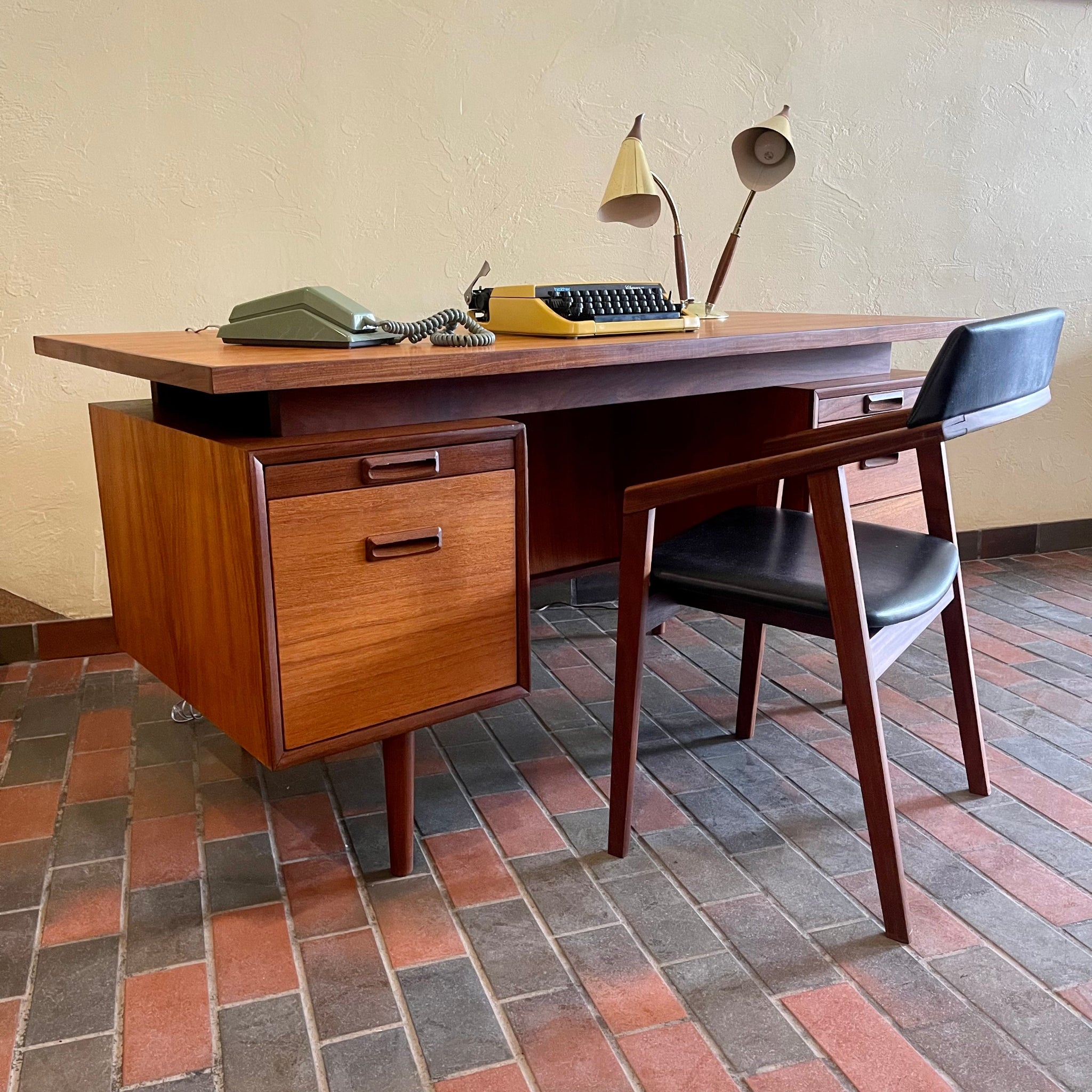 Angled view of mid-century RS Associates teak executive desk