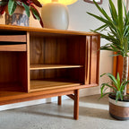 Adjustable shelving inside Danish teak tambour door credenza