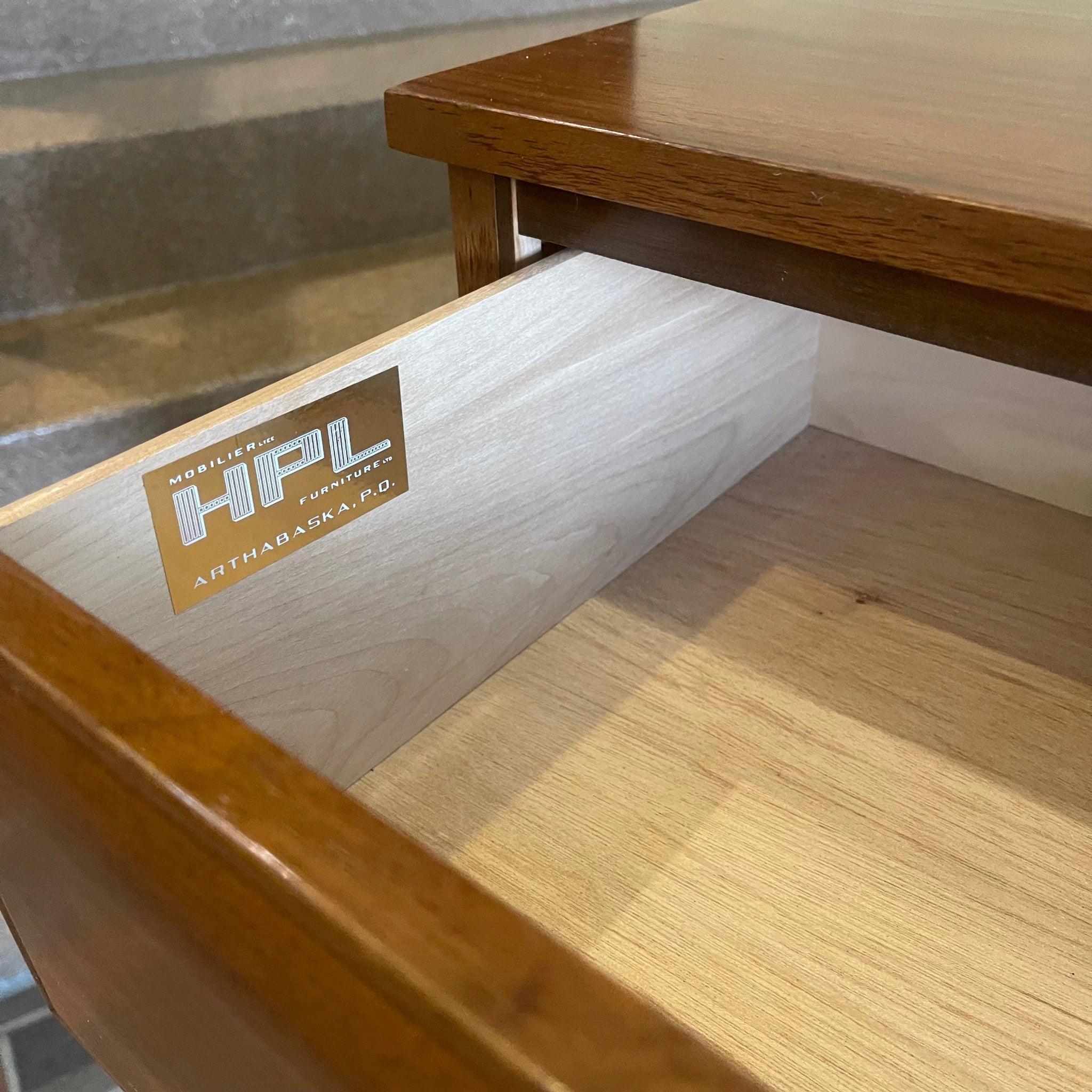 Close-up of HPL Furniture label on nine drawer walnut dresser