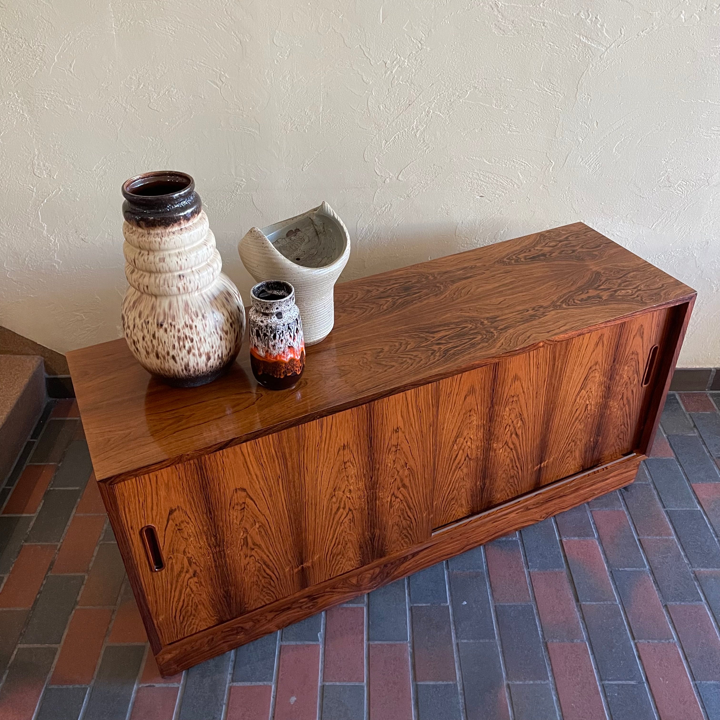 This Poul Hundevad Rosewood Credenza is crafted from rosewood, its compact size makes it perfect for apartments or smaller rooms.